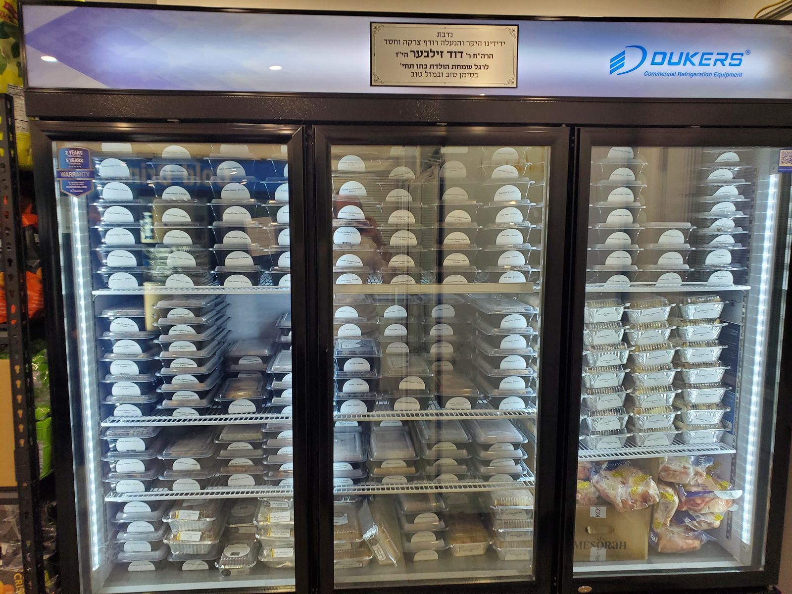 Commercial freezer stocked with prepared meals